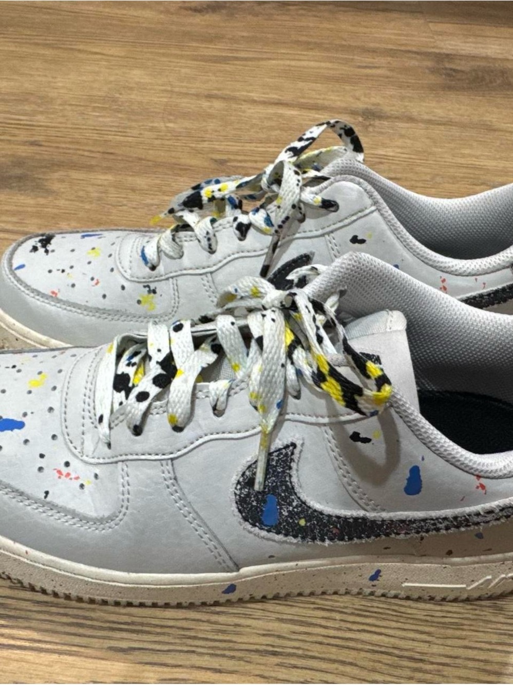 Nike White Sneakers with Black Swoosh and Multicolor Paint Splatter